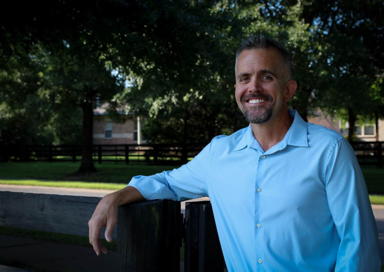 Chris Gonzales leaning on a wooden fence in Ward 4